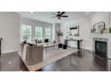 Light-filled living room with fireplace, hardwood floors, and stylish neutral furniture at 4905 Greylock Se Walk, Atlanta, GA 30339