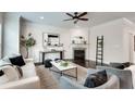 Bright living room features a cozy fireplace, modern decor, and hardwood flooring at 4905 Greylock Se Walk, Atlanta, GA 30339