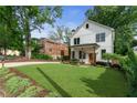 Charming two-story home with a manicured lawn, walkway, and fresh landscaping at 1671 Laurel Nw Ave, Atlanta, GA 30318