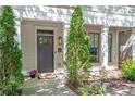 Charming townhome entry with a gray front door, manicured landscaping, and classic architectural details at 175 Stovall Se St, Atlanta, GA 30316