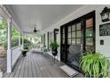 Inviting front porch with ceiling fan, wicker furniture, and decorative plants at 2130 Monticello Pl, Lawrenceville, GA 30043