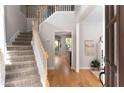Bright foyer with staircase and hardwood floors, creating a welcoming entrance at 630 Bluff Oak Ct, Roswell, GA 30076