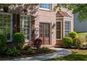 Elegant home entrance featuring a double door with glass insets, decorative shutters and manicured landscaping at 630 Bluff Oak Ct, Roswell, GA 30076