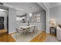 Elegant dining room with modern lighting, seating for six, and views of the kitchen at 850 Piedmont Ne Ave # 2509, Atlanta, GA 30308