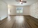 Open-concept living room with hardwood floors and a decorative stone wall at 1098 Eastview Ne Cir, Conyers, GA 30012