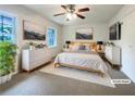 Serene staged bedroom featuring plush bedding, stylish dressers, and neutral decor at 1098 Eastview Ne Cir, Conyers, GA 30012