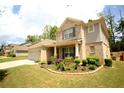 Beautiful two-story home featuring brick and siding, professional landscaping, and an attached two car garage at 1142 Terrasol Rdg, Lilburn, GA 30047