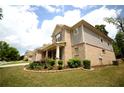 Brick home with professional landscaping featuring green lawn, bushes, and various flowers near the front porch at 1142 Terrasol Rdg, Lilburn, GA 30047
