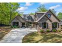 Stunning brick and stone home with a spacious driveway and a three-car garage at 1188 Woodtrace Ln, Auburn, GA 30011