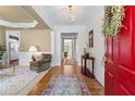 Elegant foyer with hardwood floors, decorative chandelier, and views into the living spaces at 1315 Badingham Dr, Cumming, GA 30041