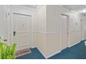 Inviting hallway featuring neutral walls, blue carpet, and stylish trim detail at 6851 Roswell Rd # B15, Sandy Springs, GA 30328