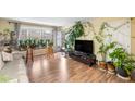 Airy living room with wood floors, a large window, and an open doorway to the outdoors at 6851 Roswell Rd # B15, Sandy Springs, GA 30328