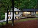 Attractive white home with black trim has a welcoming front porch and well-maintained landscaping at 2152 Tourney Dr, Marietta, GA 30062