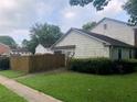 A single-story home with muted blue shutters is sided with unpainted clapboards and a fenced front yard at 2617 Terrace Pkwy, Morrow, GA 30260