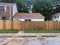 A single-story home with a brown roof is protected by a new wooden fence at 2617 Terrace Pkwy, Morrow, GA 30260