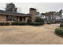 Charming brick home with a stone chimney and dormant landscaping in a suburban neighborhood at 3358 Stonecrest Ct, Atlanta, GA 30341