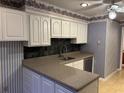 A well-lit kitchen featuring white cabinets and neutral countertops, creating a functional cooking space at 3358 Stonecrest Ct, Atlanta, GA 30341