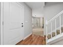 Entryway featuring wood floors that transition to carpet with views into the living room at 706 Cather Ct, Stone Mountain, GA 30088