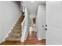 Inviting entryway featuring hardwood floors, staircase, and a view into the adjacent rooms at 706 Cather Ct, Stone Mountain, GA 30088