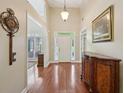 Welcoming foyer featuring wood floors, high ceilings, and a decorative buffet cabinet at 5030 Princeton Trce, Cumming, GA 30041