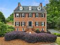 Beautiful brick home featuring symmetrically aligned windows and a manicured front yard at 100 Barnard Pl, Atlanta, GA 30328