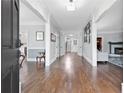 Bright foyer with hardwood floors, view of the staircase, and open to the living room at 100 Barnard Pl, Atlanta, GA 30328