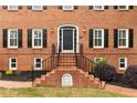Traditional brick home with a welcoming front entrance and well-maintained landscaping at 100 Barnard Pl, Atlanta, GA 30328
