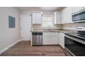 Well-lit kitchen featuring stainless steel appliances and granite countertops, next to door at 1774 Austin Dr, Decatur, GA 30032