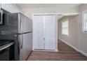 Updated kitchen with modern stainless steel refrigerator and a view to other room through closet door at 1774 Austin Dr, Decatur, GA 30032