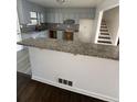 Open kitchen featuring granite counters, gray cabinets, and stainless steel appliances at 1905 Rollingwood Se Dr, Atlanta, GA 30316