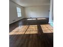 Hardwood flooring and a large window flood the living room with natural light at 1905 Rollingwood Se Dr, Atlanta, GA 30316
