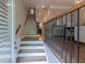 Inviting foyer featuring a staircase with wooden handrail and elegant wrought iron balusters at 2448 Gatebury Cir, Atlanta, GA 30341