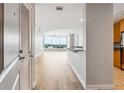 Inviting entrance hall with hardwood floors, offering views of a bright living area and modern kitchen at 3338 Peachtree Rd # 1210, Atlanta, GA 30326