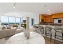 Open-concept living space featuring a modern kitchen, dining area, and comfortable seating with a view at 3338 Peachtree Rd # 1210, Atlanta, GA 30326