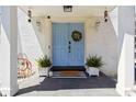 Welcoming front entrance with a charming blue door, decorative wreath, and potted plants at 4909 Glenwhite Dr, Duluth, GA 30096