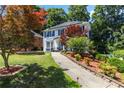 Beautiful two-story home with lush landscaping and a charming walkway leading to the front door at 4909 Glenwhite Dr, Duluth, GA 30096