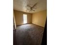 Bedroom with carpet, ceiling fan, and natural light from a window at 2436 Rex Rd, Ellenwood, GA 30294
