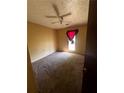 Bedroom with carpet, ceiling fan, and natural light from a window at 2436 Rex Rd, Ellenwood, GA 30294