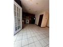 Kitchen area with tiled floor, white appliances, and dark cabinetry at 2436 Rex Rd, Ellenwood, GA 30294
