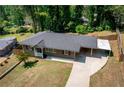 An aerial shot displays the home's layout, including the carport, fenced backyard, and mature trees at 2685 Flagstone Se Dr, Atlanta, GA 30316