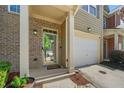 Inviting entryway with brick accents, covered porch, and a convenient attached garage at 3366 Thornbridge Dr, Powder Springs, GA 30127