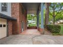 A covered brick side patio with a view of the neighborhood homes at 1055 Heather Ct, Lawrenceville, GA 30043