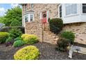 Inviting entrance with brick steps, bay windows, and vibrant landscaping at 1470 Rhododendron Nw Dr, Acworth, GA 30102