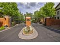 View of the neighborhood entrance with brick pillars, wrought iron gates, and decorative landscaping at 3127 Lenox Ne Rd # 1, Atlanta, GA 30324