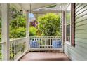 Relax on the covered front porch swing with decorative pillows at 865 Ashland Ne Ave, Atlanta, GA 30307