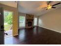 Bright living room with hardwood floors and a stone fireplace at 1231 Providence Way, Lawrenceville, GA 30046