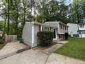 Charming two-story home with gray siding and red shutters in a wooded setting at 2036 Countydown Ln, Stone Mountain, GA 30088