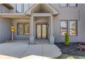 Stately gray brick home featuring a covered front entrance with stone columns and meticulous landscaping at 37 Deer Canyon Dr, Auburn, GA 30011