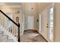 Bright foyer features a staircase, wood-look floors, and a view of the front door at 5574 Wynhall Dr, Peachtree Corners, GA 30071
