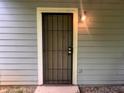 Exterior door with an added security door and outdoor lighting at 5769 Shadow Creek Dr, Lithonia, GA 30058